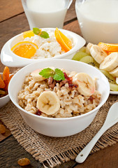 Healthy breakfast - oatmeal, cottage cheese, milk and fruit