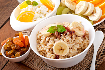 Healthy breakfast - oatmeal, cottage cheese, milk and fruit