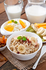 Healthy breakfast - oatmeal, cottage cheese, milk and fruit