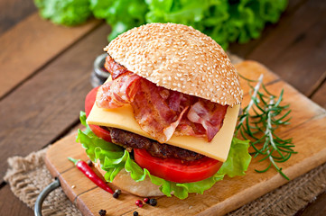 Big sandwich - hamburger burger with beef, cheese, tomato, bacon