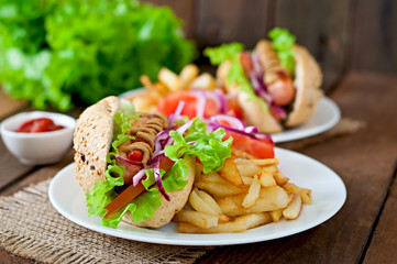 Hot Dogs with French fries on white plate, close-up