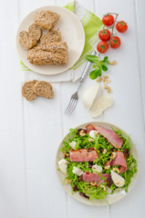 Arugula salad with meat and mozzarella