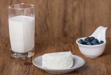 blueberries and milk products on wooden table