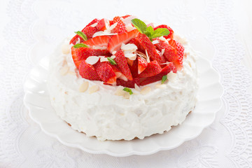 delicious cake with whipped cream and strawberries on a plate
