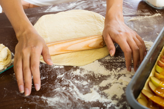 Closeup of woman preparing cakes