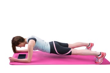 Pretty brunette doing plank on fitness mat