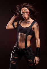 Attractive girl in sexy military uniform holding a knife