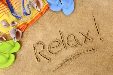Fototapeta na wymiar Relax word text message written in sand on a tropical beach with seashells and accessories summer holiday vacation relaxation photo