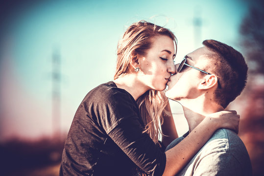 Pretty couple kissing outdoor in the forest