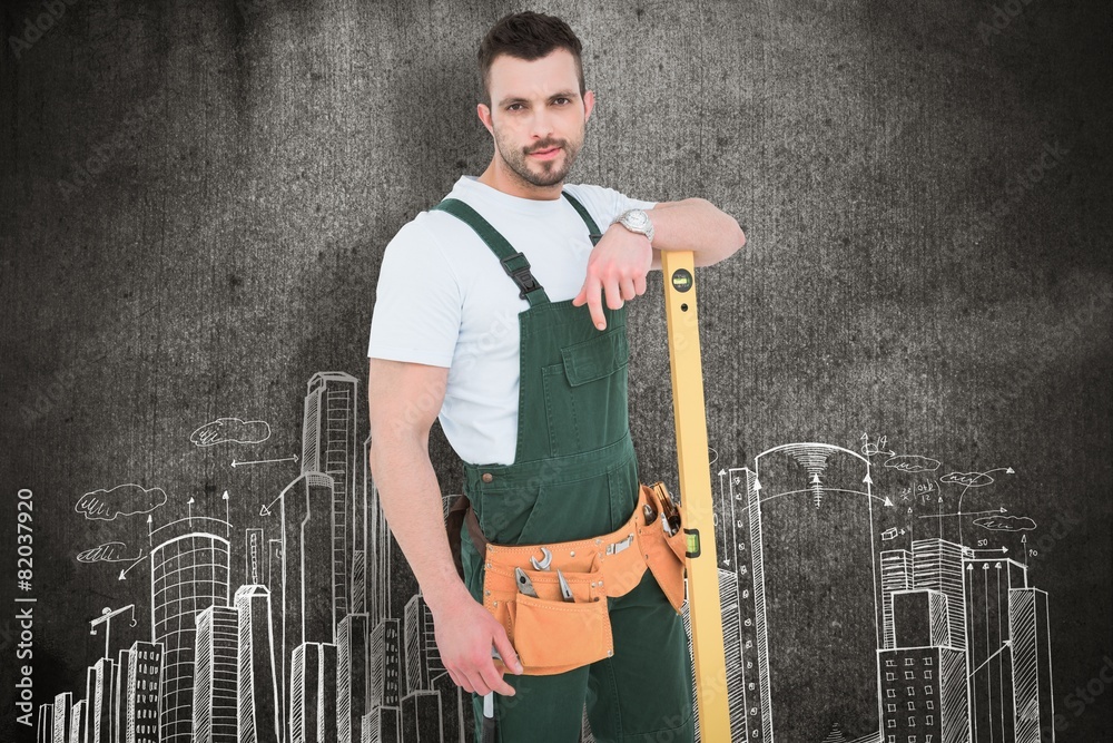 Poster carpenter smiling to camera with spirit level