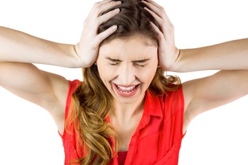 Pretty brunette shouting with hands on head