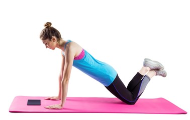 Fit woman doing press up on mat