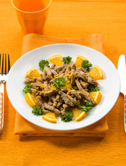 meat stew with orange sauce and orange peel