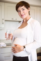 Pregnant woman having a glass of water