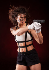 elegant and sexy lady with a gun pistol in hands. woman killer