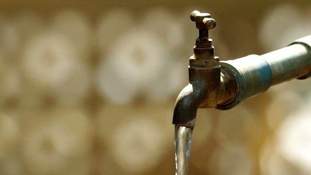 water is flowing from the old style tap