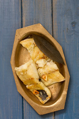 fried fish on dish on blue background