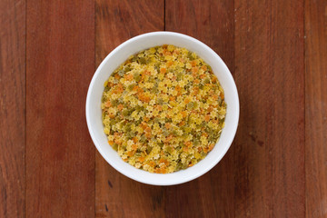 pasta stars in white bowl on brown background