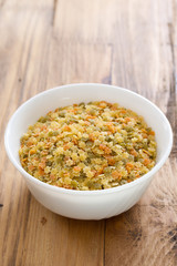 dry pasta stars in white bowl on brown background