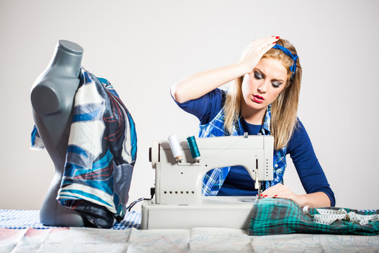 Woman sews and getting frustrated because she made a mistake