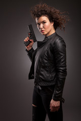 elegant and sexy lady with a gun pistol in hands. woman killer