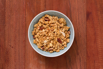 granola in bowl in brown background