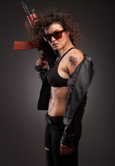 Fototapeta na wymiar Beautiful woman with gun ak 47