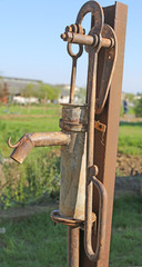 rusted fountain with the lever to pump water