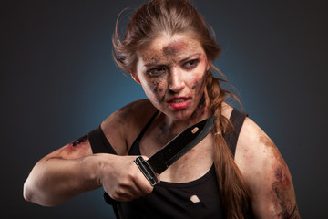 Sexy and hot military woman posing with knife. Ready to fight.