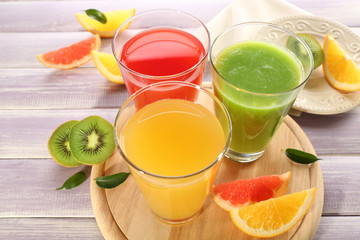 Fresh juices with fruits on wooden table