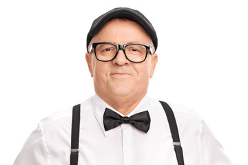 Portrait of a stylish senior with a beret and a bow-tie