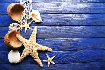 Sea stars and shells on wooden background