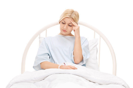 Worried female patient lying in a hospital bed