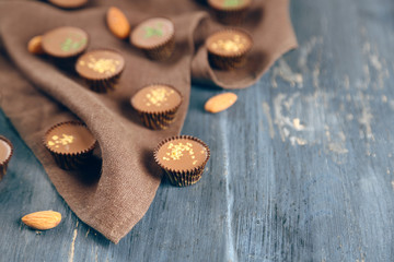 Tasty chocolate candies on napkin, on wooden table