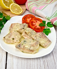 Fish stew in sauce on plate with lemon