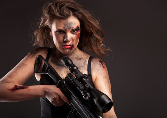 Riot girl with sniper gun close up portrait. 