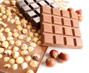Black and milk chocolate bars with hazelnuts isolated on white