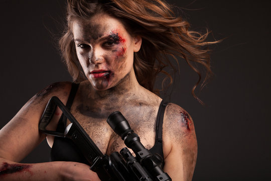 Riot girl with sniper gun close up portrait. 