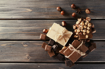 Set of chocolate with hazelnut on wooden table, top view
