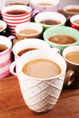 Cups of cappuccino on wooden table, closeup