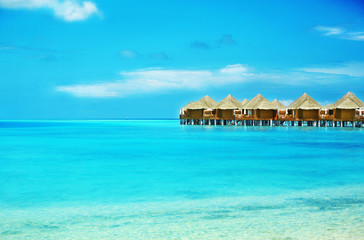 View of beautiful blue ocean water and bungalows in Baros