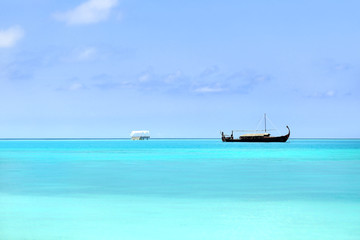 Fototapeta na wymiar View of beautiful blue ocean water with boat in Baros Maldives