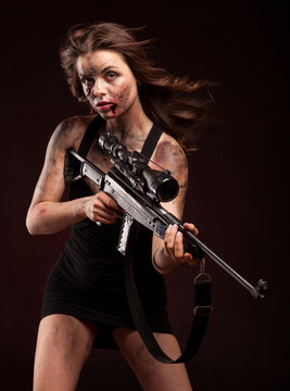 girl with sniper gun close up portrait. With blood and wound
