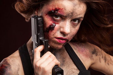 Woman warrior posing with knife. Ready to fight. With dirty face