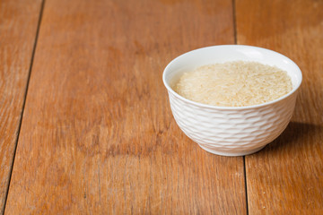Uncooked rice in white bowl