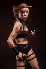 Woman warrior posing with knife. Ready to fight. With dirty face