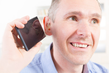 Hearing impaired man using mobile phone