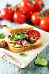 Tasty sandwich on wooden table, close up