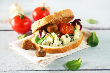 Tasty sandwich on wooden table, close up