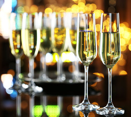Glasses of champagne on bar background